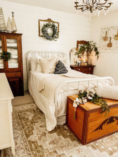 a bedroom with a bed, dresser and chest in it's centerpieces