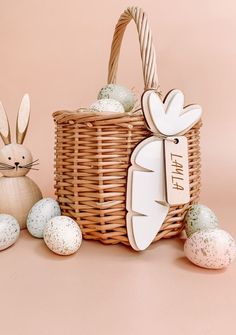 an easter basket with bunny ears and eggs in it, next to a rabbit figurine