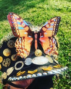 Black and Gold Butterfly festival hat! In the style of burning man captain hats. Handmade and comfy to wear. One off unique creation with a huge butterfly on the front, gold under the chin hanging chain and iridescent gold and black sequins. Such a luxurious and stand out piece that shines beautifully in the sun.  Made with pure love and excitement. Unique Adjustable Costume Hats And Headpieces For Festival, Bohemian Festival Hats And Headpieces For Carnival, Bohemian High Crown Hat For Festivals, Fantasy Costume Hat With High Crown For Festivals, Fantasy Festival Costume Hat With Round Crown, Fantasy Costume Hat With Round Crown For Festivals, High Crown Costume Hats For Carnival, Adjustable High Crown Festival Costume Hat, Adjustable Gold Costume Hats And Headpieces For Carnival