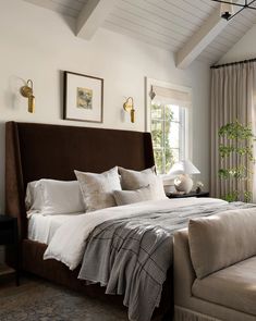 a large bed sitting under a window in a bedroom