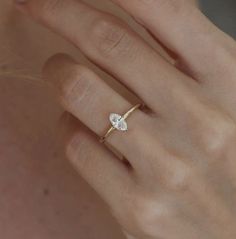 a woman's hand with a diamond ring on it