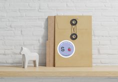 a small toy horse next to a brown bag on a shelf with a white brick wall behind it