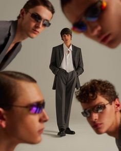 three men in suits and sunglasses looking at each other with one man's reflection