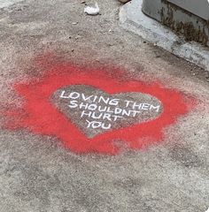 a heart shaped chalk drawing on the ground