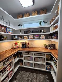 an organized pantry with lots of shelves and baskets on the top, below a skylight