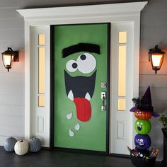 a green door decorated with an image of a monster