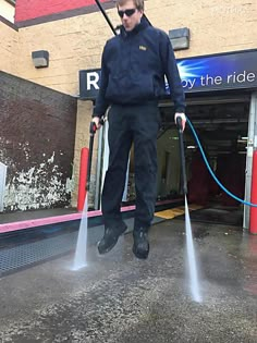 a man is spraying water on the street