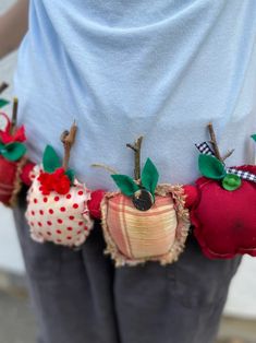 a person is wearing an apple belt with apples on it