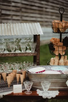 an assortment of desserts and wine glasses on a table