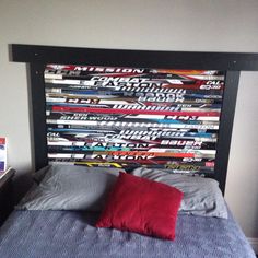 a bed that has some skis on the headboard and pillows in front of it