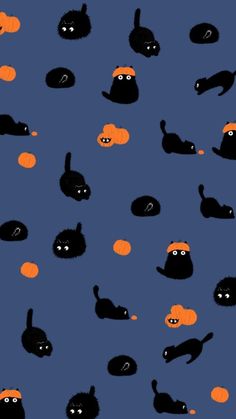 black cats and pumpkins on a blue background with orange balls in the shape of faces