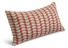 a red and beige pillow on a white background