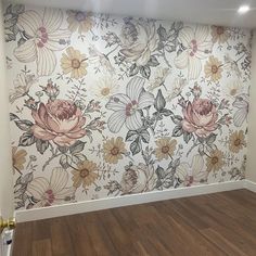 an empty room with flowers painted on the wall