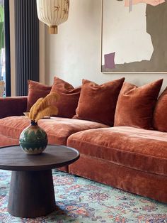 a living room filled with lots of furniture and pillows on top of it's couches