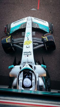 the front end of a racing car on a track