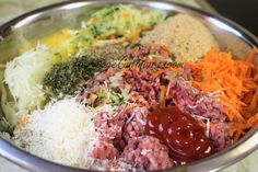 a metal bowl filled with different types of food