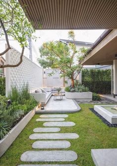 a modern garden with stepping stones in the grass