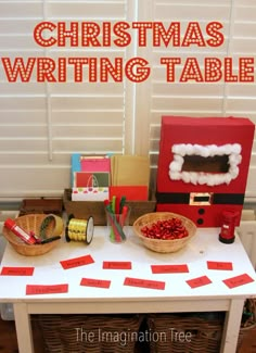 a christmas writing table with santa's hat on it and other items around the table