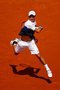 a tennis player in mid air after hitting the ball