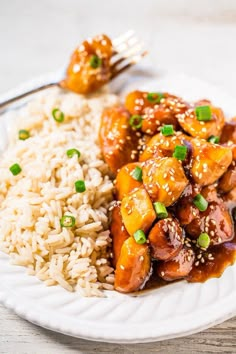 a white plate topped with meat and rice