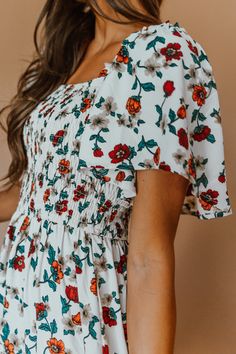 This lightweight flowy floral dress is an instant favorite to twirl our way from season to season. The perfect cross between boho and classic. A subtle square neckline, stretchy smocked bodice, and flutter shoulder sleeve are reason enough to fall in love. Missionary Dresses, Dresses For Engagement Pictures, Frog Socks, Lady Pants, Kenya Fashion, Caroline Dress, Flowy Floral Dress, Sweet Caroline, Church Dresses