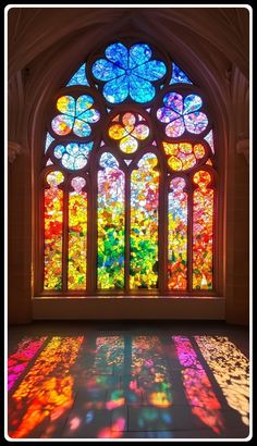 a large stained glass window sitting inside of a building next to a floor covered in light