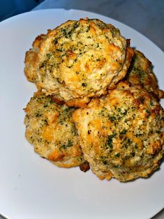 three crab cakes on a white plate