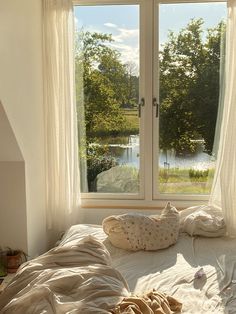 an unmade bed sitting in front of a window