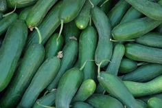 cucumbers are piled on top of each other