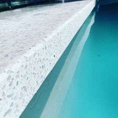 an empty pool with blue water in the middle