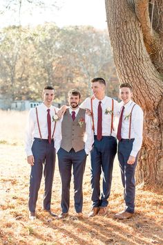 a group of men standing next to each other under a tree