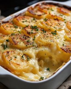 a casserole dish with potatoes and parmesan cheese