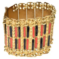 This beautiful vintage Grecian cuff bracelet is a combination of red and black enamel set against gold plated metal with chain and link work. It is from the 50's. It is marked Made In Greece. There is a long pin that closes the bracelet into cuff form. Great with even a simple white tee and jeans. This will be a stunning addition on your arm for day or evening wear. The dimensions are 2" diameter on the interior and 2" H. The bracelet when opened up flat is 7" L or wide when you take the pin off Elegant Red Enamel Bracelets, Antique Gold Enamel Bracelets, Vintage Gold Enamel Bracelets, Elegant Red Metal Cuff Bracelet, Gold Bracelet With Black Enamel, Antique Red Bracelet For Formal Occasions, Red Antique Bracelet For Formal Occasions, Red Metal Costume Jewelry Bracelets, Formal Red Metal Bracelets