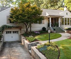 a large white house with landscaping around it