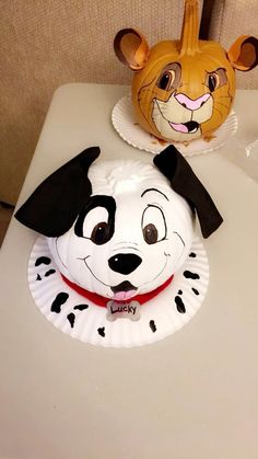 a paper plate with a dog and cat face on it sitting on top of a table