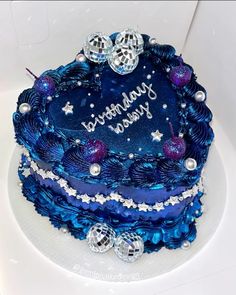 a birthday cake with blue frosting and decorations