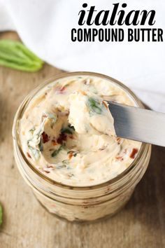 a spoon in a jar filled with homemade italian compound butter