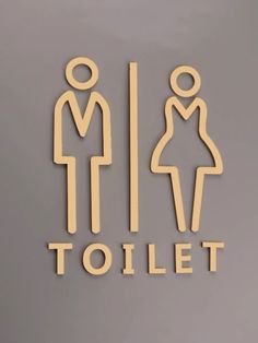 a sign that says toilet with a man and woman in the bathroom on it's side