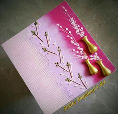 two bells on top of a pink card