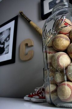 a jar filled with baseballs sitting on top of a table