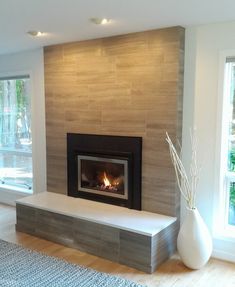 a living room with a fire place and large windows