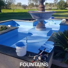 a fountain being painted with blue paint