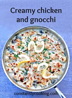 creamy chicken and gnocchi in a pan with lemons