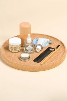 an assortment of beauty products on a cork tray