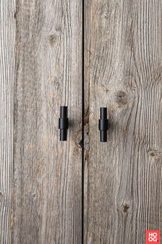 an old wooden door with two black handles