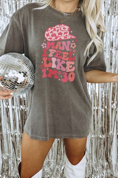 "Get ready to be OBSESSED with your new \"Man I Feel Like I'm 30\" Comfort Colors graphic tee. It's the cutest and most trendy way to emit all those important country western 30th Birthday vibes!  Find the matching \"Let's Go Girls\" shirt here: https://www.etsy.com/listing/1461006185 DETAILS * Comfort Colors Garment-Dyed Heavyweight T-Shirt * 100% ring spun cotton  * Design is printed using DTG technology which uses high-quality water-based inks that are printed directly into the fabric.  This Cowgirl Birthday, Cowgirl Shirts, Bridal Party Shirts, 30th Birthday Gifts