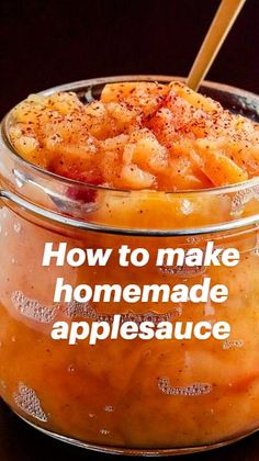 a glass jar filled with homemade applesauce sitting on top of a wooden table