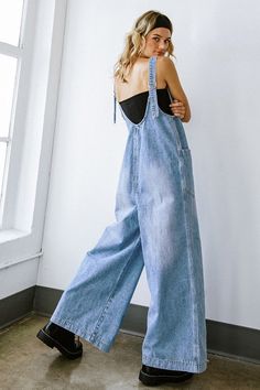 A washed denim overall featuring a V neckline, large front pockets, wide leg, plunging back and adjustable straps. 100% Cotton Runs true to size. Model is wearing a small. 34” bust, 26” waist, 35” hips, 5’6”) Waist Hips Inseam Length Small 40 inches 42 inches 27 inches 59 inches Medium 42 inches 44 inches 27 inches 59 inches Large 44 inches 46 inches 27 inches 60 inches We measure each item from side seam to side seam, on a flat surface. Please consider the fabric content of each item, as fabric Womens Clothing Aesthetic, Cute Overalls, Flying Tomato, Washed Denim, Denim Overalls, Jeans Jumpsuit, Denim Jumpsuit, V Neckline, Light Denim