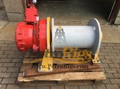 a red and white fire hydrant sitting on top of a pallet next to a building