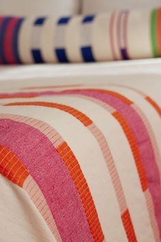 an image of a bed with colorful stripes on it